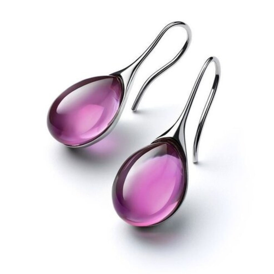 "Pendientes de Cristal en Oro y Plata" can be rewritten as "Aretes de Cristal en Oro y Plata".