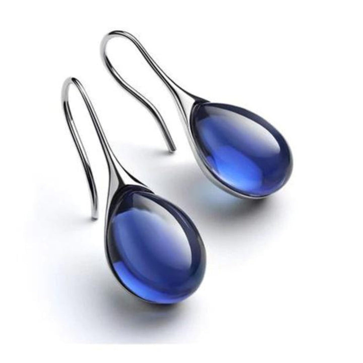 "Pendientes de Cristal en Oro y Plata" can be rewritten as "Aretes de Cristal en Oro y Plata".