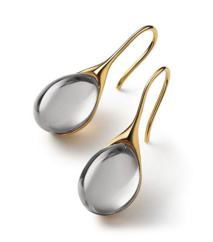 "Pendientes de Cristal en Oro y Plata" can be rewritten as "Aretes de Cristal en Oro y Plata".